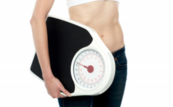 Image of woman holding a scale courtesy of stockimages/freedigitalphotos.net 