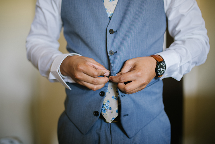 Groom Buttoning Blue Vest | Should the Groom Wear a Suit or a Tuxedo? | Details Nashville | The Pink Bride® www.thepinkbride.com