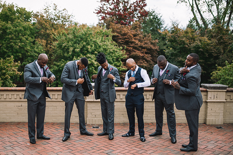 Groom in tux shop and groomsmen in suits